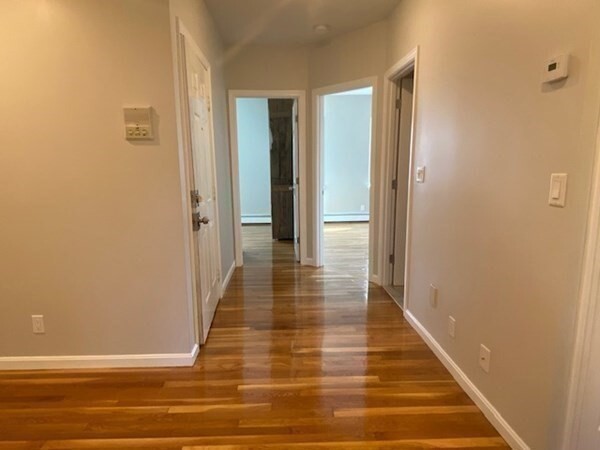 131 West Seventh Street, Unit 2 Boston, MA 02127 - Photo 9 of 11 a view of a hallway with wooden floor