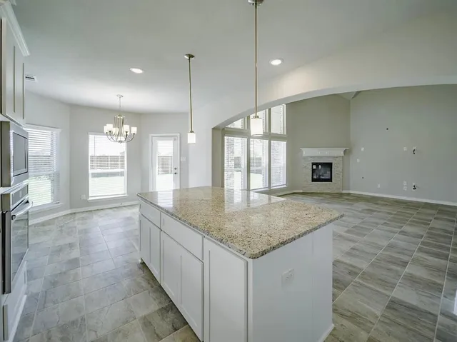 a kitchen with a stove and cabinets