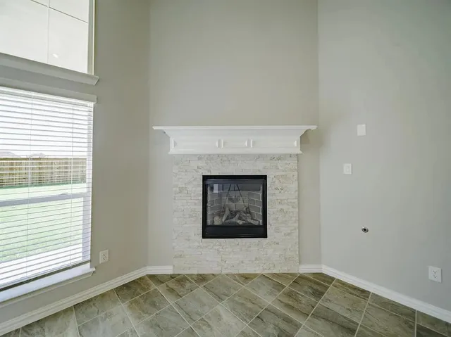 a kitchen with stainless steel appliances granite countertop a sink a stove a refrigerator cabinets and a kitchen island