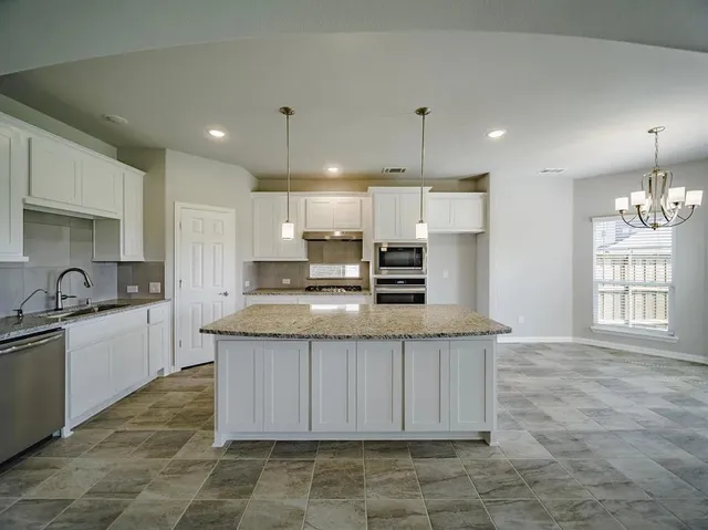 a kitchen with sink and stove