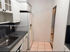 a kitchen with a sink and a refrigerator