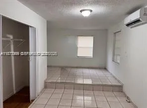 a bathroom with a granite countertop sink toilet a mirror and shower
