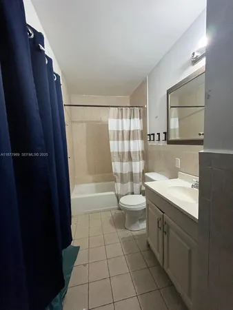 a view of a room with wooden floor and bathroom
