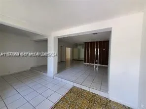 a view of a hallway to closet and natural light