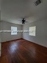 a view of a room with wooden floor