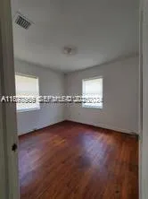 a view of an empty room and a window