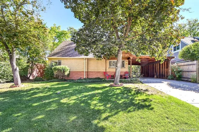 a backyard of a house with table and chairs