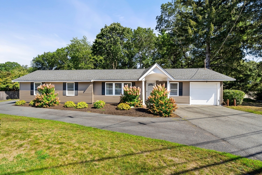 a front view of house with yard outdoor seating and barbeque oven
