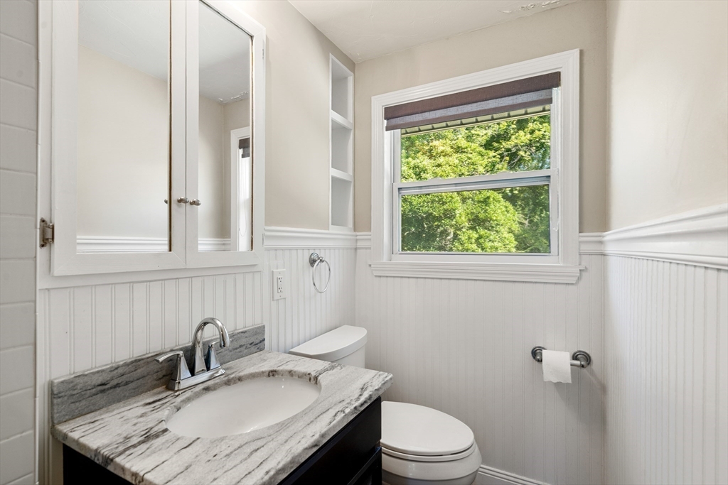 40 Randolph Street Canton, MA 02021 - Photo 11 of 35 a bathroom with a granite countertop sink a toilet and a window