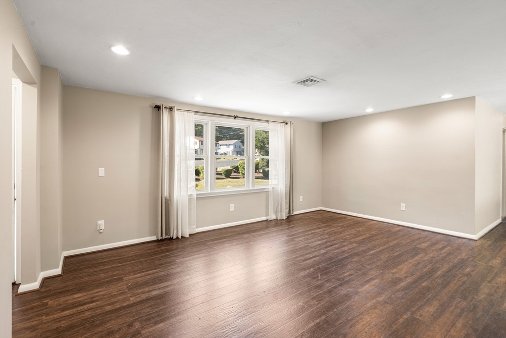 40 Randolph Street Canton, MA 02021 - Photo 8 of 35 a view of an empty room with wooden floor and a window