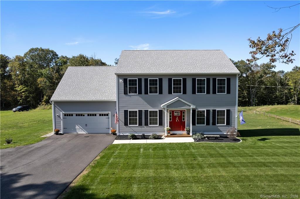 a front view of a house with a yard table and chairs