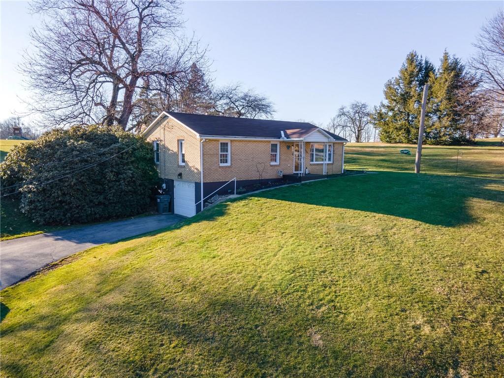 319 Moran Road Butler, PA 16002 - Photo 21 of 24 a view of house with yard and trees in the background