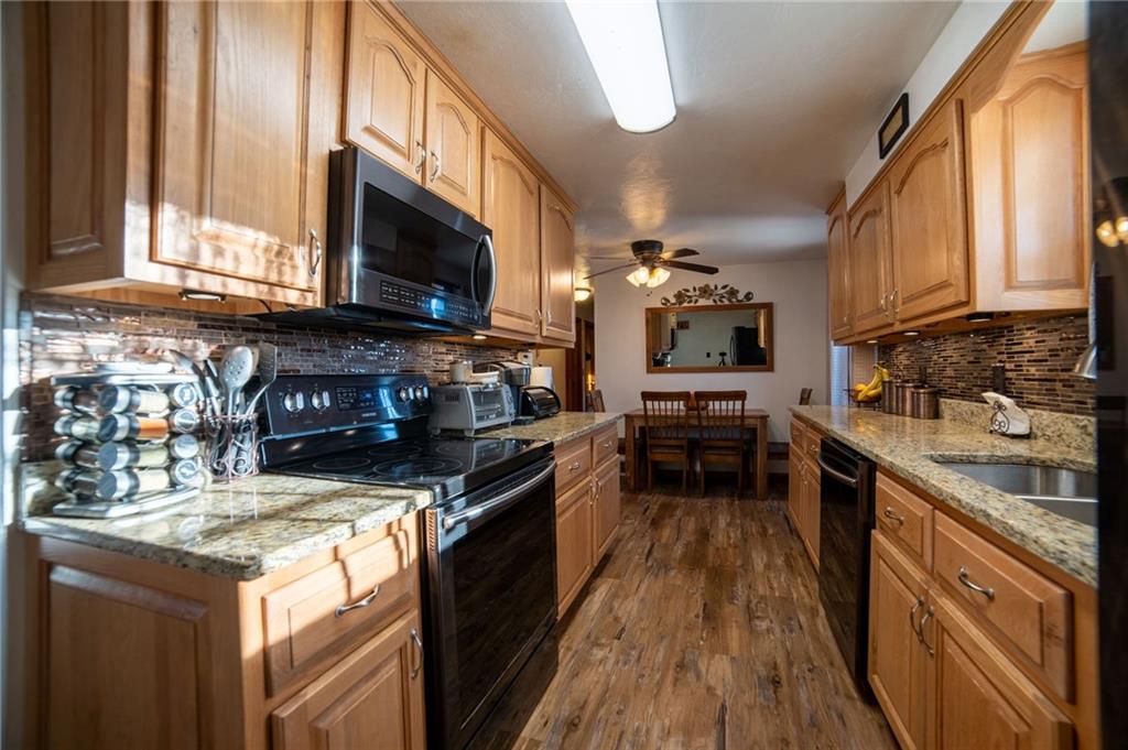 319 Moran Road Butler, PA 16002 - Photo 10 of 24 a kitchen with stainless steel appliances granite countertop a stove top oven a sink dishwasher and a microwave oven with cabinets