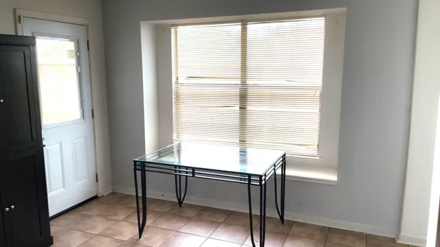 a room with windows and pool table