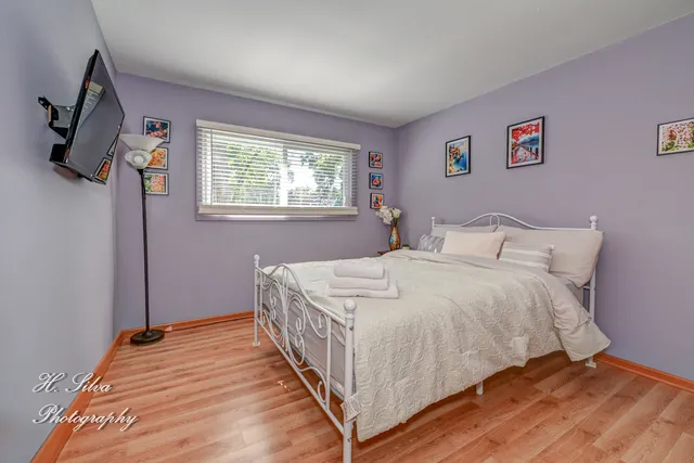 a bedroom with a bed and a window