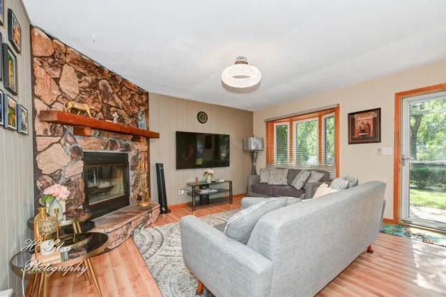 a living room with furniture a flat screen tv and a fireplace