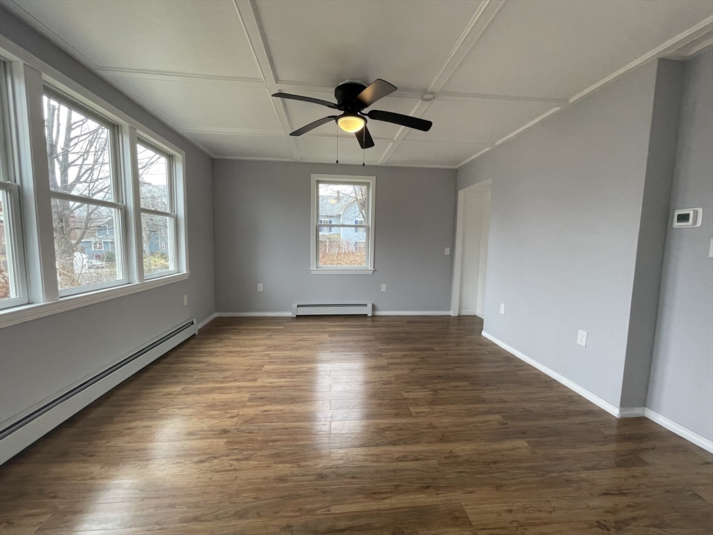 59 High Street Warren, MA 01083 - Photo 4 of 42 an empty room with wooden floor chandelier fan and windows