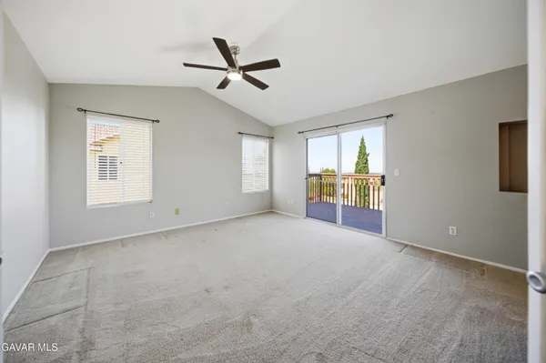 a view of a livingroom with a ceiling fan and window