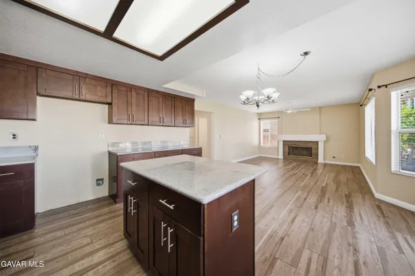 a kitchen with a stove and wooden floor