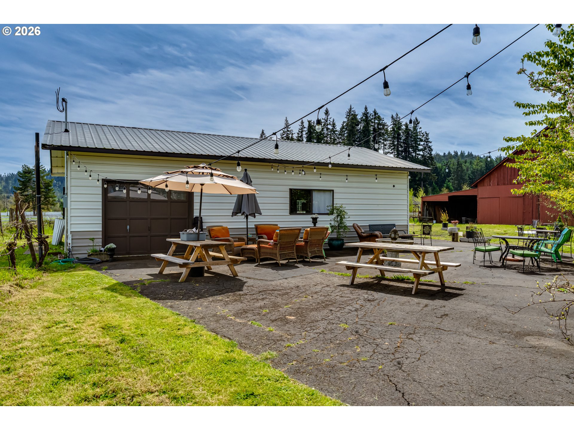 34386 Mathews Road Eugene, OR 97405 - Photo 11 of 48 a view of a patio with table and chairs under an umbrella
