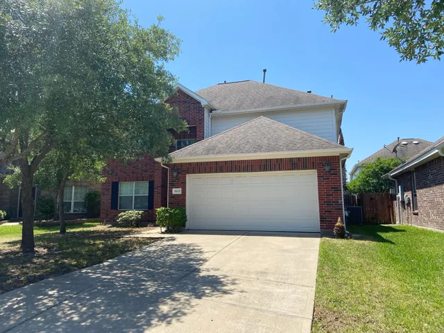 a front view of a house with a yard and a garage