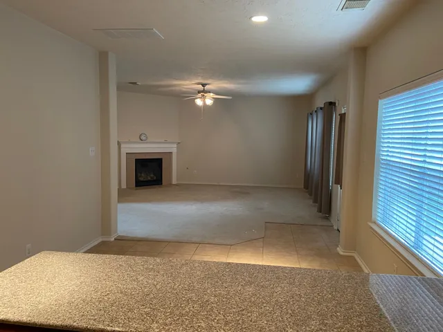 wooden floor in an empty room with a fireplace