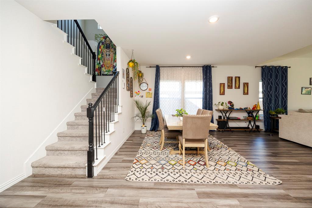 495 Fox Ridge Drive Princeton, TX 75407 - Photo 8 of 31 Wood-finish flooring, recessed lighting, carpeted staircase with black balusters, and white interior walls