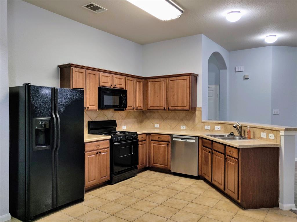 4428 Bent Path Round Rock, TX 78665 - Photo 4 of 17 a kitchen with stainless steel appliances granite countertop a refrigerator stove a sink dishwasher and microwave oven