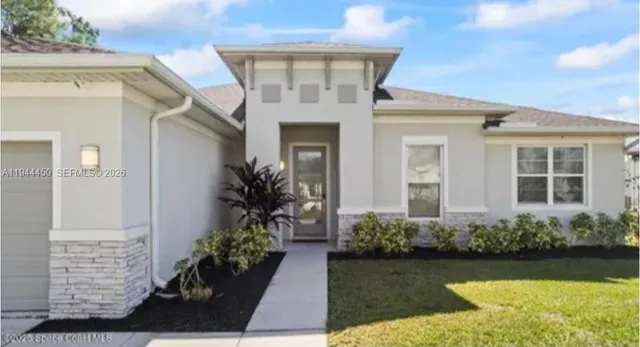 a front view of a house with garden