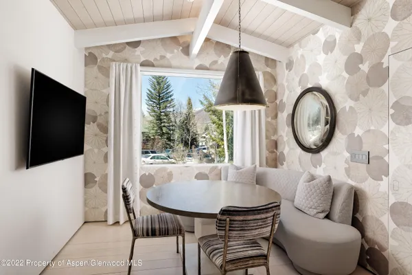 a living room with furniture a flat screen tv and a large window