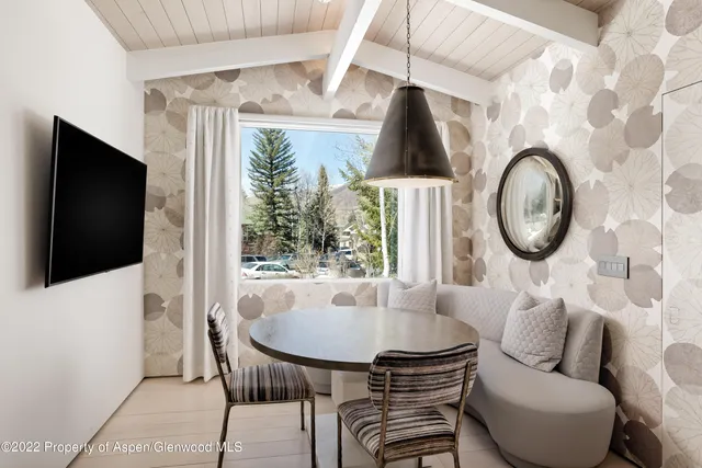 a living room with furniture a flat screen tv and a large window