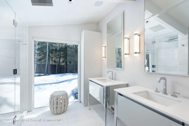 a bathroom with a sink double vanity and a mirror