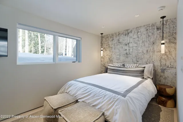 a bedroom with a bed and a chair