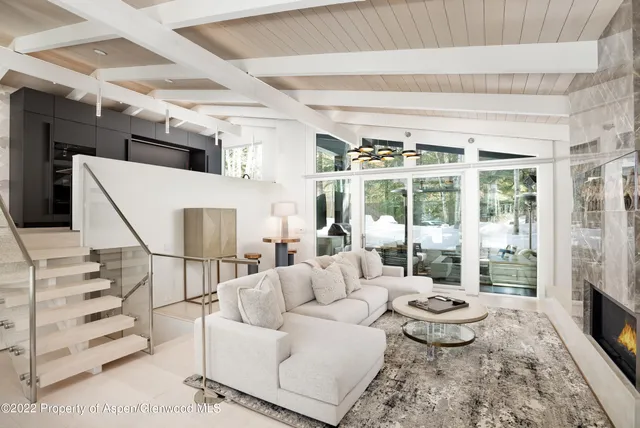 a living room with furniture and a floor to ceiling window