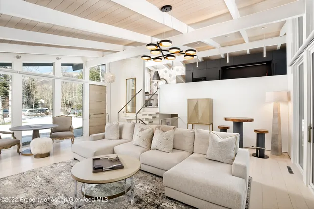 a living room with furniture and a chandelier