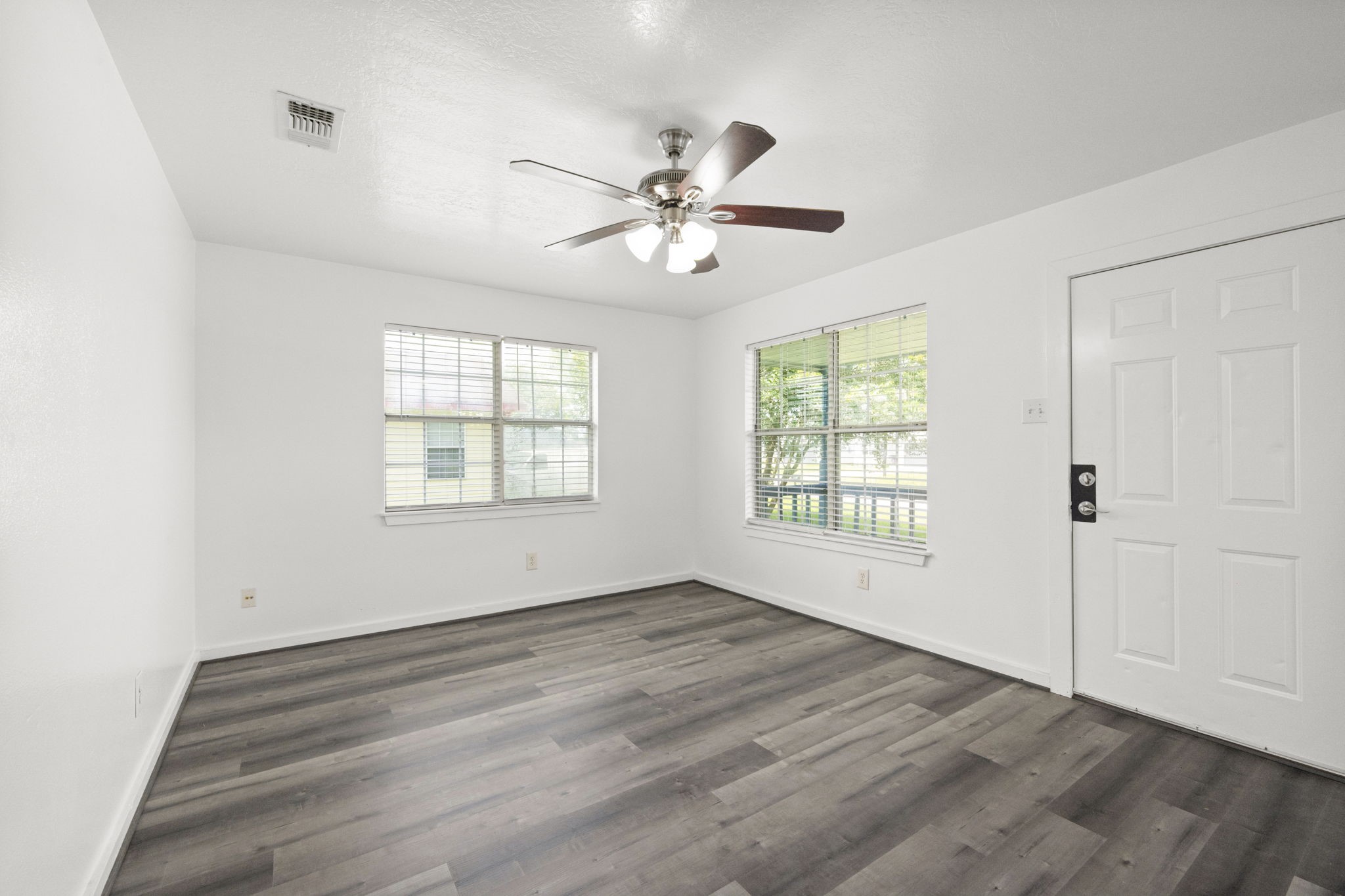 1935 1st Street Hempstead, TX 77445 - Photo 14 of 29 a view of empty room with wooden floor and fan