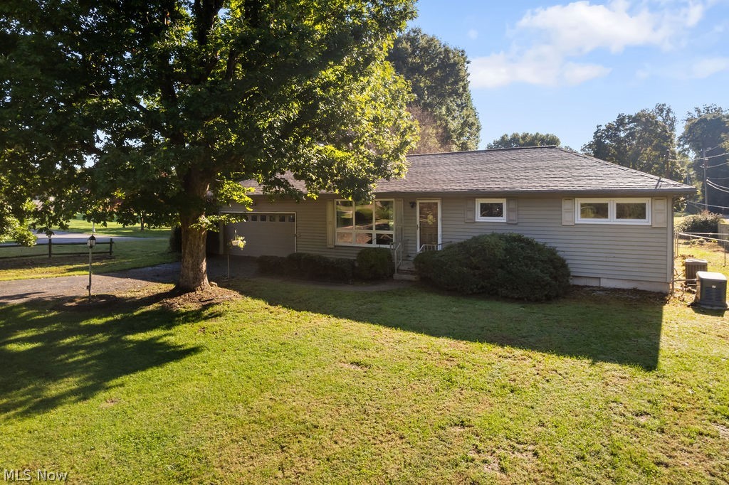11363 Dupont Road Washington, WV 26181 - Photo 30 of 42 Single-story residence featuring light gray siding, dark shingle roofing, and a two-car garage