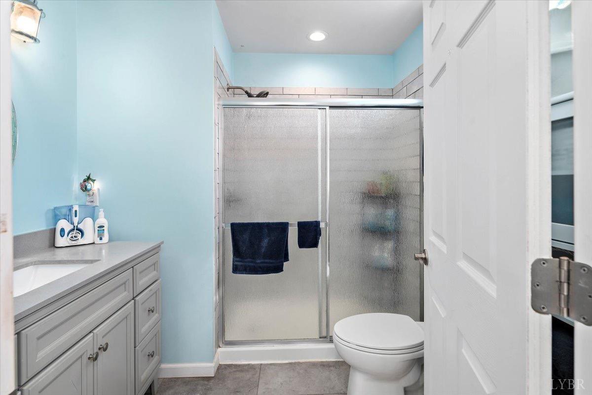 854 Kenmore Road Amherst, VA 24521 - Photo 16 of 37 a bathroom with a sink a toilet and shower