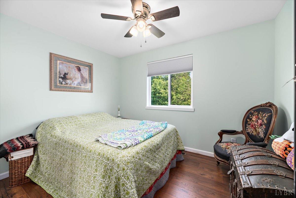 854 Kenmore Road Amherst, VA 24521 - Photo 19 of 37 a bedroom with a bed and wooden floor
