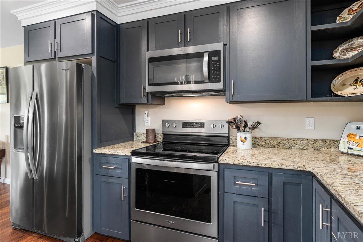 854 Kenmore Road Amherst, VA 24521 - Photo 7 of 37 a kitchen with granite countertop a stove microwave and refrigerator