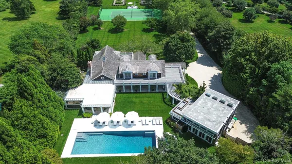 an aerial view of a house with a yard