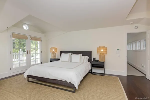 a open kitchen with stainless steel appliances granite countertop a barbecue grill and couches next to a large window