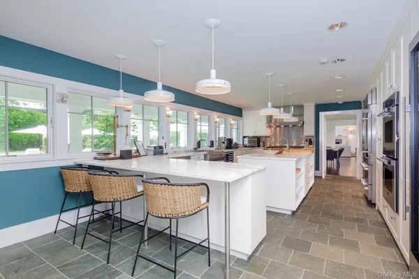 a kitchen with granite countertop stainless steel appliances a stove a sink and a microwave