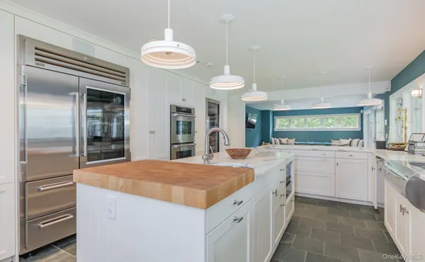 a kitchen with a stove top oven a sink and a window