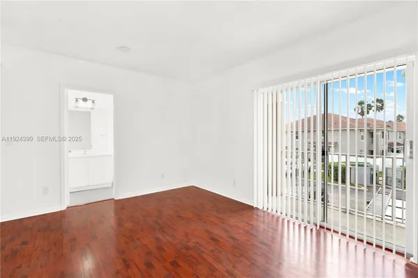 a view of a room with wooden floor and windows