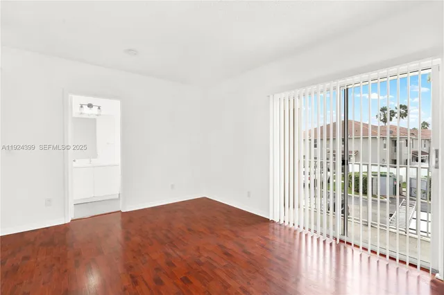 a view of a room with wooden floor and windows