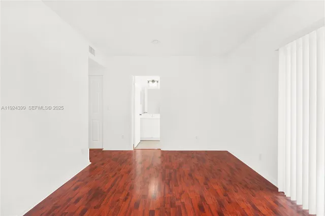 a view of a room with wooden floor