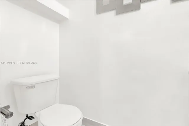 a white toilet sitting next to a white sink