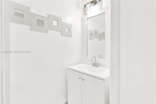 a bathroom with a sink a mirror and a shower