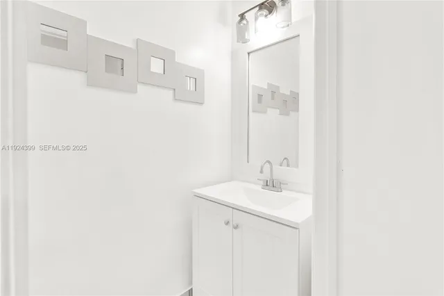 a bathroom with a sink a mirror and a shower